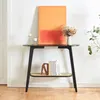 A black console table with a rattan shelf, decorated with a painting, flowers, candles, and decorative objects. Anteprima dell’immagine prodotto