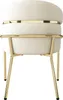 A close-up, front-facing view of a beige upholstered chair with gold metal legs and accents. Produktbild-Vorschau