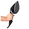 A hand holds a black garment steamer. Podgląd zdjęcia produktu