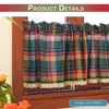 A close-up view of plaid curtains with lace trim hanging in a window frame. Náhled obrázku produktu