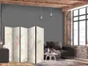 A room interior with a sofa, a coffee table, and a room divider. Náhled obrázku produktu
