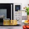 A close-up of a microwave oven's control panel and door, with food items in the foreground and background. Produktbild-Vorschau