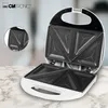 An open white sandwich maker with black non-stick plates, shown on a marble countertop. Produktbild-Vorschau