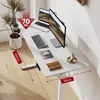 A white standing desk with two monitors, a laptop, keyboard, mouse, a plant, and decorative items. Podgląd zdjęcia produktu