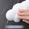 A hand is cleaning a white cloud-shaped wrist rest with a wipe. The background is a dark marble surface. Text at the bottom reads 'Easy Clean-Up'. Podgląd zdjęcia produktu