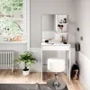A white vanity table with a mirror and stool, set up in a room with a window and a plant. Podgląd zdjęcia produktu