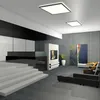 A modern living room with a sleek design, featuring a fireplace, artwork, and furniture. Produktbild-Vorschau