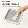 A hand is shown rinsing a square ice cream pan with water, with a spatula inside the pan. Náhled obrázku produktu