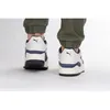 A rear view of two Puma Slipstream Alwayson sneakers worn by a person wearing green pants. Podgląd zdjęcia produktu