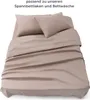A taupe bed sheet and pillowcases are neatly arranged on a bed. Náhled obrázku produktu