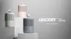 Three dehumidifier units in different colors are displayed on white pedestals against a light gray background. Text indicating the brand and origin is present on the right. Produktbild-Vorschau