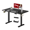 A black adjustable standing desk with a monitor, keyboard, mouse, and accessories. Náhled obrázku produktu