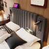 A bedroom scene with a bed, headboard, and bedside table. Náhľad obrázku produktu