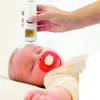 A person is using a digital thermometer on a sleeping baby. Podgląd zdjęcia produktu
