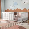 A child's bedroom with a white wooden crib and decorative clouds and stars on the wall. Náhled obrázku produktu