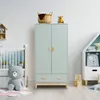 A nursery room with a wardrobe, crib, and toys. Anteprima dell’immagine prodotto