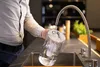 A person is filling a water filter pitcher under a faucet. Produktbild-Vorschau