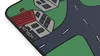 A close-up view of a desk mat with a city-themed design, featuring houses and roads. Produktbild-Vorschau