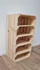 A wooden shelf unit made from crates against a white wall and wooden floor. Produktbild-Vorschau