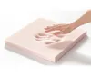 A hand pressing into a piece of pink foam. Produktbild-Vorschau