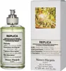 A bottle of Maison Margiela Replica Under The Lemon Trees Eau de Toilette and its packaging. Podgląd zdjęcia produktu