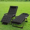 Two black reclining lounge chairs are set up on a green lawn. Voir les images du produit