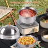 Outdoor camping scene with cooking equipment on a table. Produktbild-Vorschau