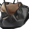 A close-up view of the interior and exterior of a black Guess shopper bag. Produktbild-Vorschau