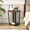 A round side table with items on it, next to a bed. Náhled obrázku produktu
