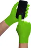 Hands wearing green nitrile gloves are holding and interacting with a smartphone. Podgląd zdjęcia produktu