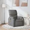 A gray fabric massage chair is placed on a rug in a room with a floor lamp and artwork on the wall. Voir les images du produit