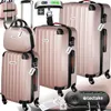 A set of rose gold luggage and accessories, including a luggage scale and tags, displayed against a light gray background. Náhled obrázku produktu