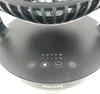 A close-up of the control panel of a black Philips desk fan. Voir les images du produit
