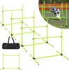 A collection of dog agility hurdles and a carrying bag are displayed on a grassy surface with a blurred background. Voir les images du produit