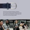 A close-up of a belt buckle and strap, with a group of people walking in the background. Anteprima dell’immagine prodotto