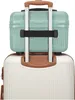 A close-up view of the top of two suitcases stacked on top of each other. The top suitcase is a mint green beauty case, and the bottom suitcase is white with brown accents. Anteprima dell’immagine prodotto