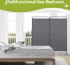 A bed in a room with a room divider placed behind it, with large windows and greenery visible outside. Voir les images du produit