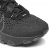 A close-up view of the toe and laces of a black Nike React Vision shoe. Voir les images du produit
