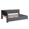 A gray upholstered bed frame with a slatted wooden base, shown from a side angle against a white background. Náhled obrázku produktu
