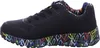 A side view of a black Skechers sneaker with a colorful, graffiti-like pattern on the sole and lining. Voir les images du produit
