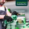 A person is using a green mini chainsaw in a workshop setting. Produktbild-Vorschau