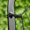 A close-up shot of a black bungee cord with a ball stopper attached to a black pole, with a black net in the background. Náhled obrázku produktu