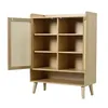 A light wood cabinet with cane doors and multiple shelves, shown with one door ajar. Produktbild-Vorschau