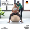 A pregnant woman sits on a large exercise ball while another woman assists her. Produktbild-Vorschau