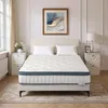 A mattress is displayed on a bed frame in a bedroom setting.