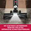 Close-up of a vacuum cleaner head on a carpet with lights on. Produktbild-Vorschau