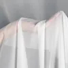 A hand holding white sheer fabric, likely a curtain, against a light gray background. Produktbild-Vorschau