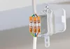 A close-up shot of electrical wire connectors attached to wires, with an open junction box in the background. Anteprima dell’immagine prodotto