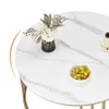 A close-up view of a round marble-effect coffee table with a vase of flowers and a small bowl of grapes. Produktbild-Vorschau