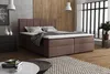 A bedroom scene with a bed, nightstand, and a rug. Voir les images du produit